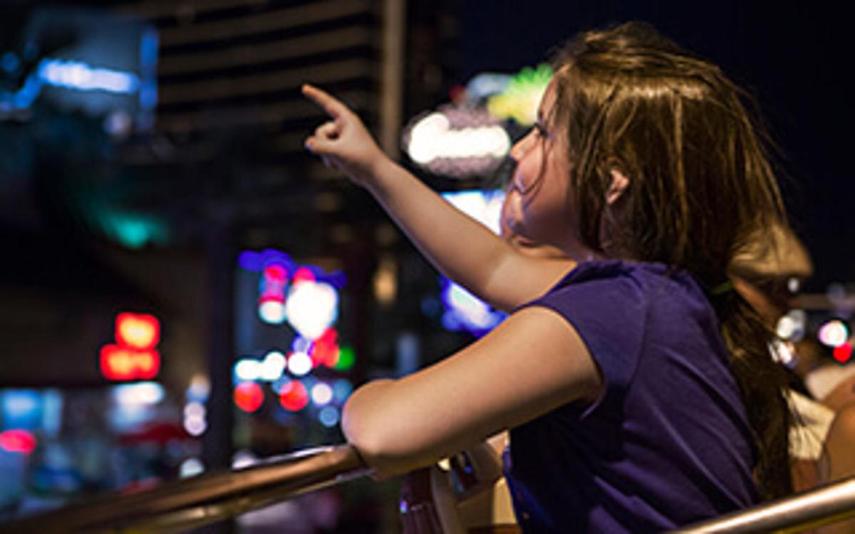 a young woman pointing her finger at a city