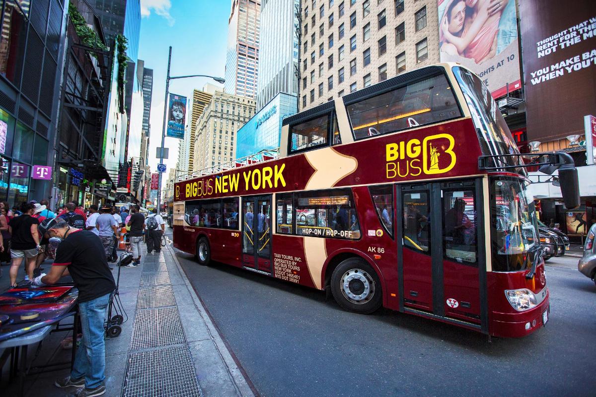 a red double decker bus on a city street