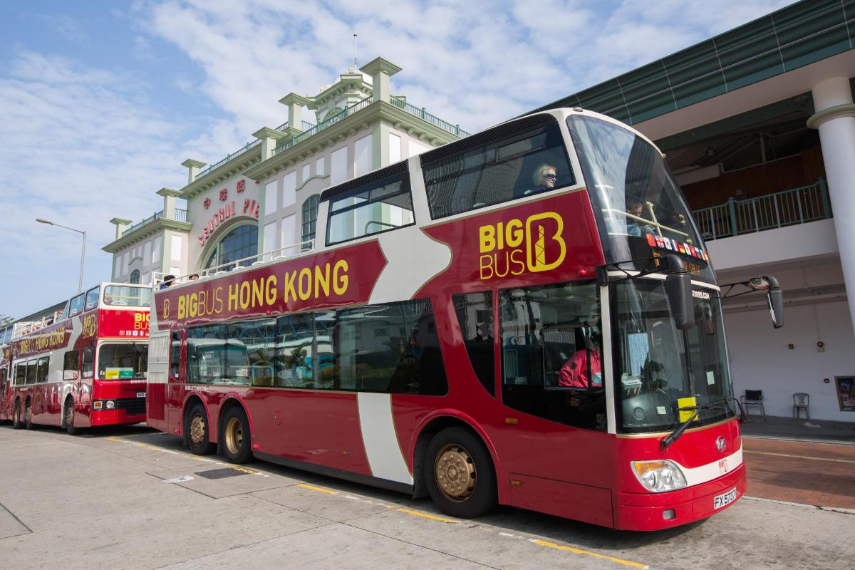 two red double decker buses parked in front of a building