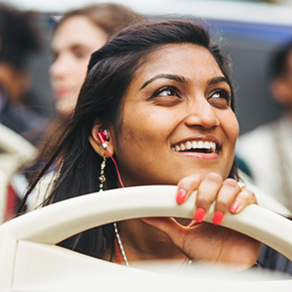 a woman smiling while sitting on a chair