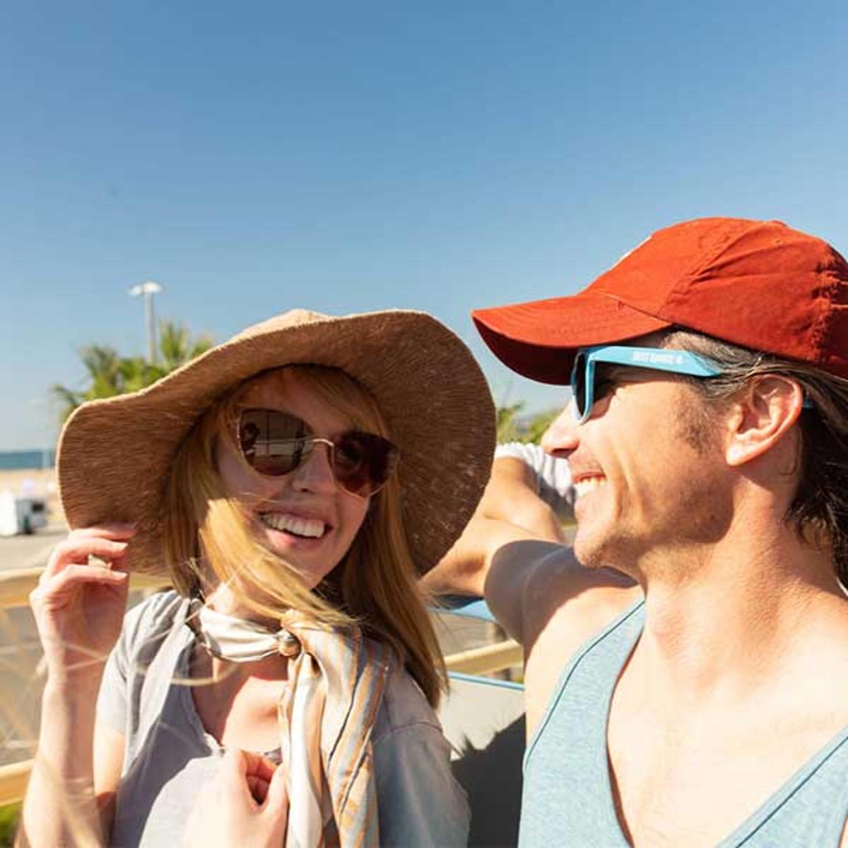 a man and a woman wearing hats standing next to each other