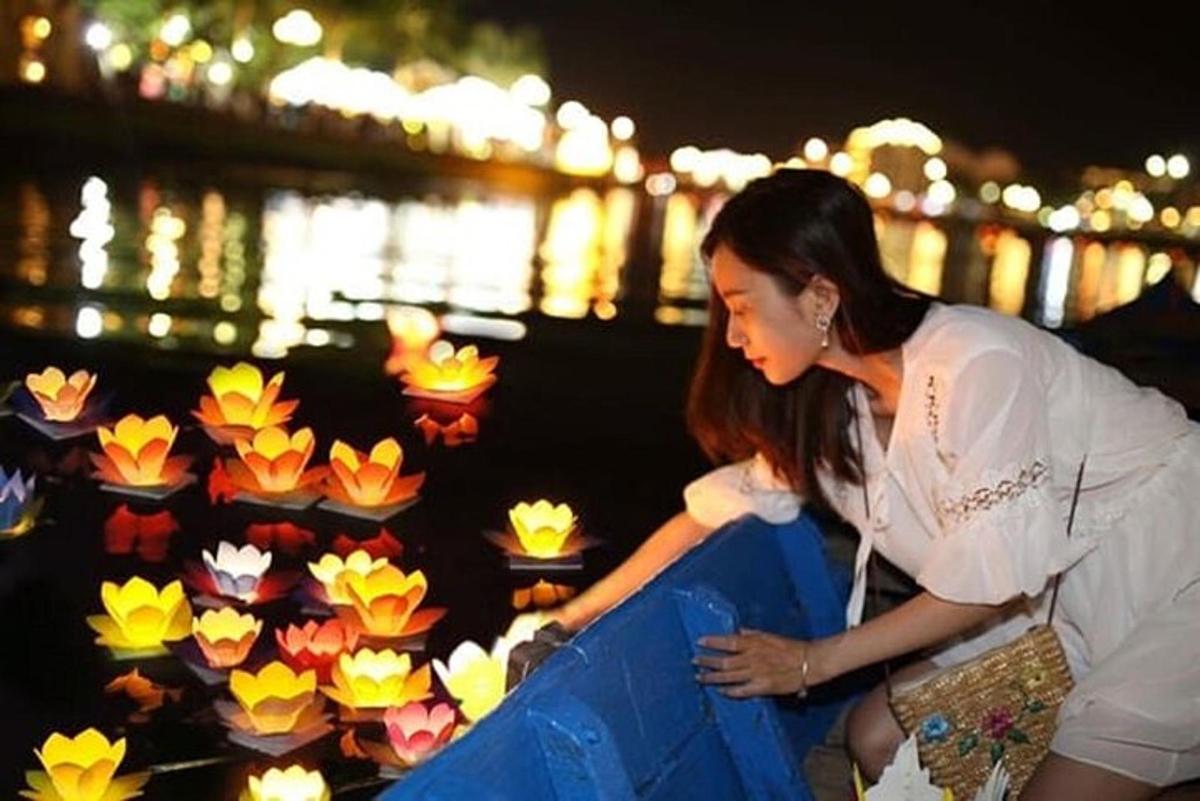 a woman is looking at a display of paper flowers