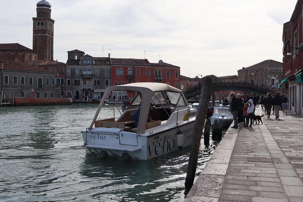 a boat is docked on a canal in a city