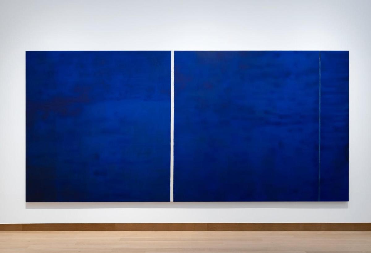a large blue painting on a white wall