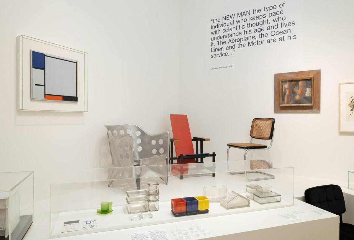 a display case in a museum with several chairs