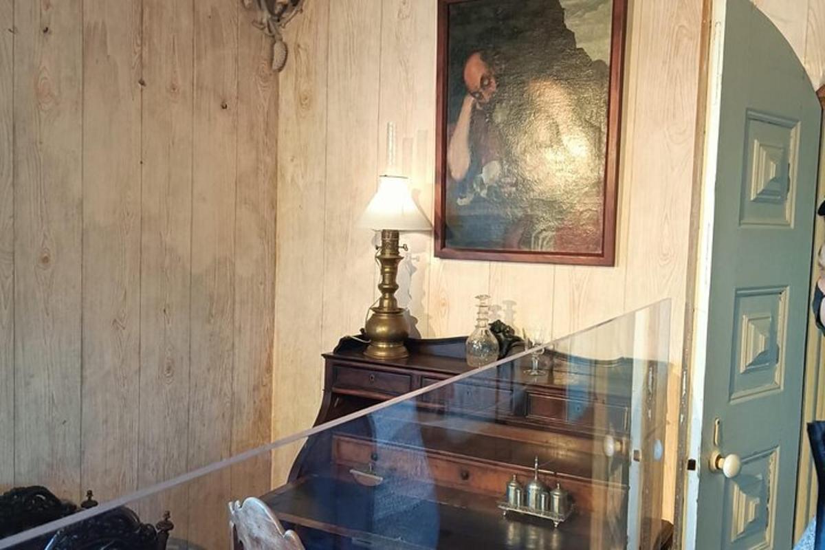 a stairway with a lamp and a picture on the wall