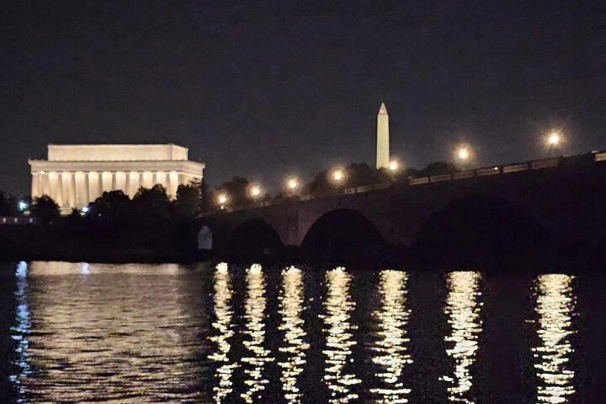 a bridge over a river at night with lights