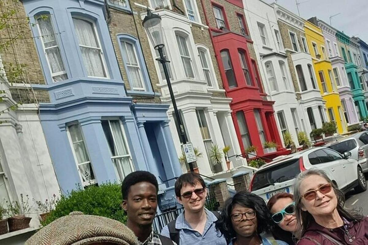 a group of people standing in front of a row of houses