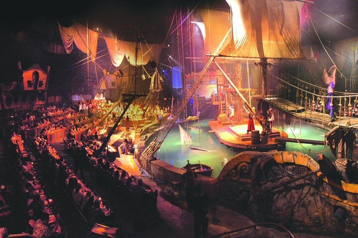 a stage with a crowd of people and boats on it