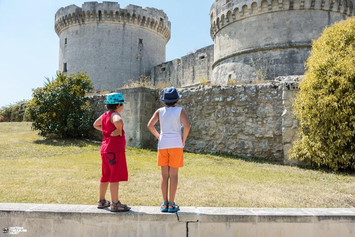 two children standing on a wall in front of a castle