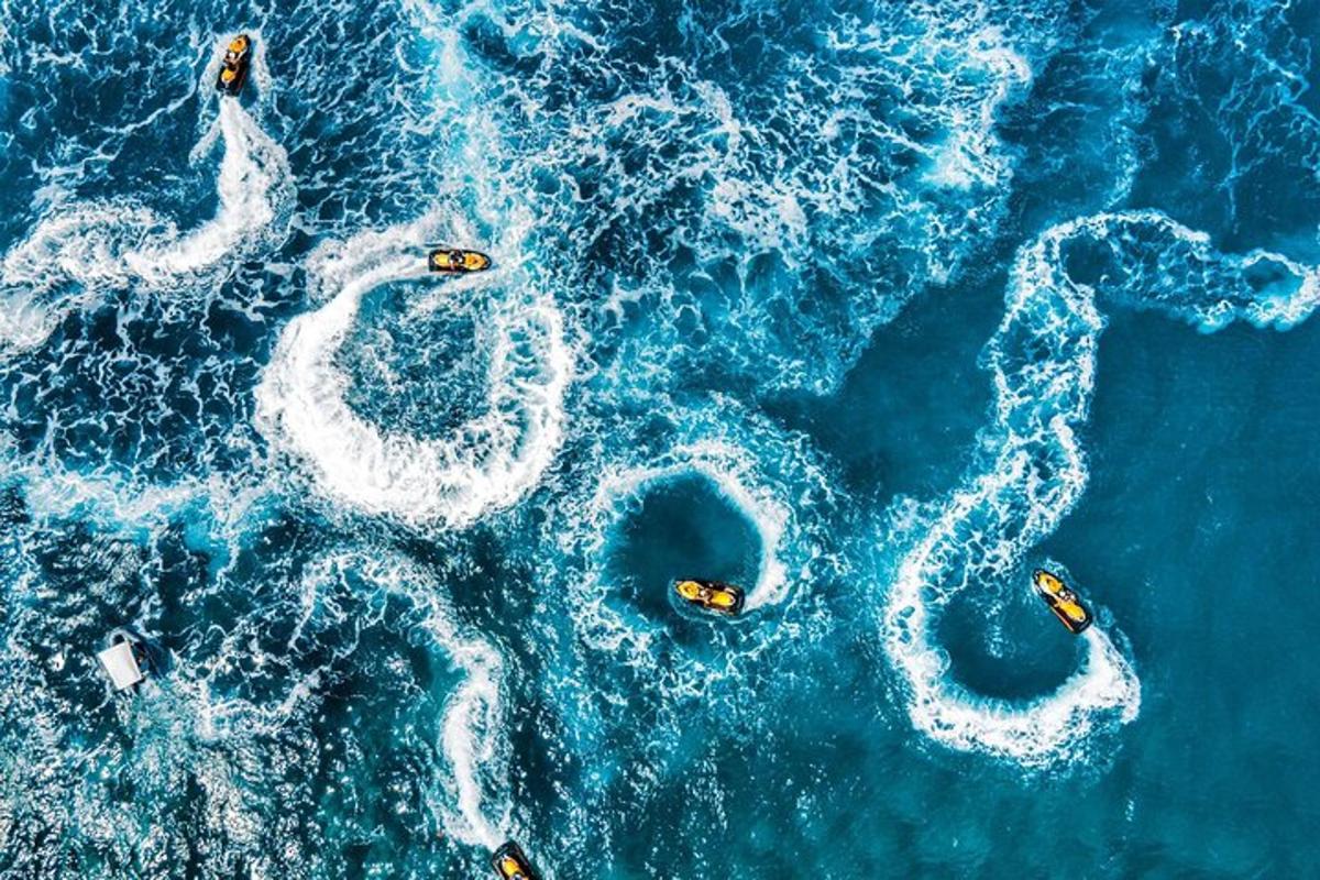 an aerial view of the ocean with boats in the water