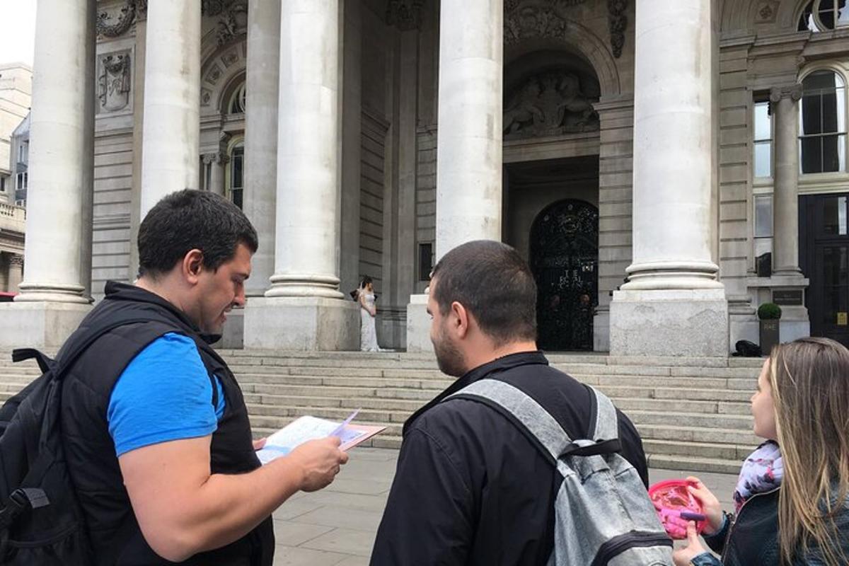 μια ομάδα τριών ατόμων που στέκονται μπροστά σε ένα κτίριο
