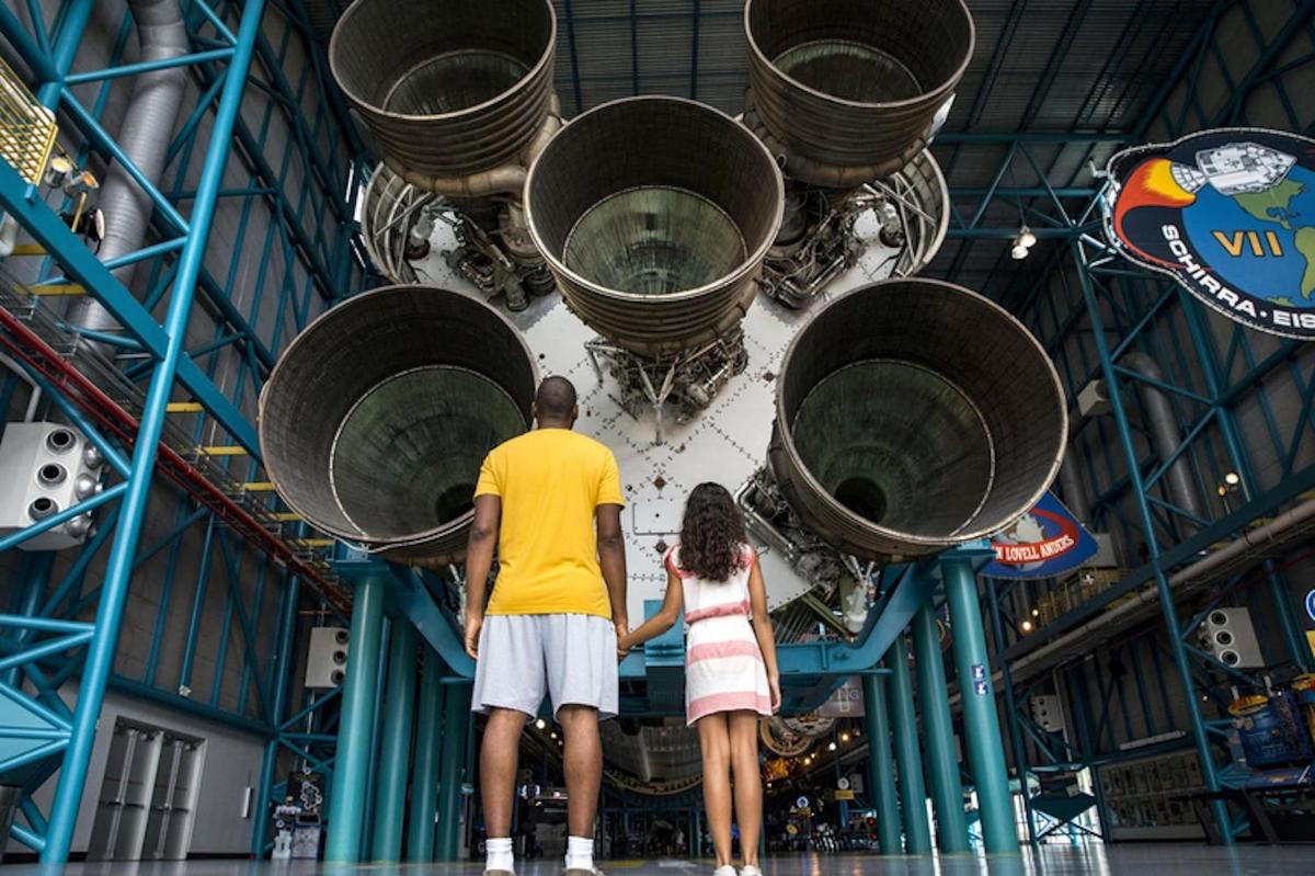 ein Mann und eine Frau stehen vor einer Rakete