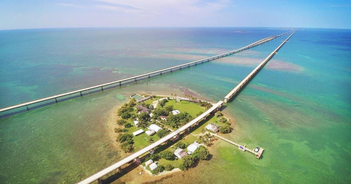 an aerial view of a bridge over the ocean