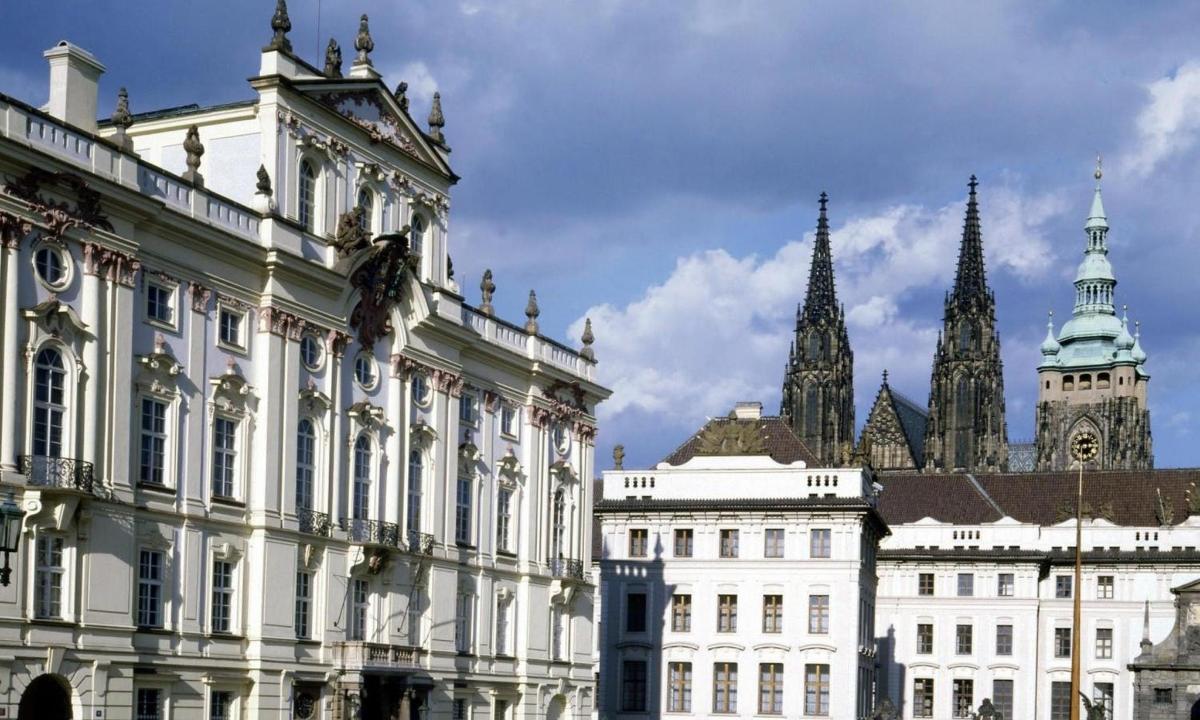 a group of buildings with a clock tower in the background