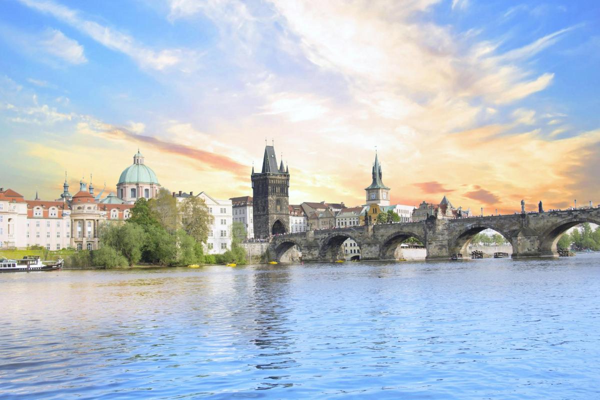 a bridge over a river with buildings in the background