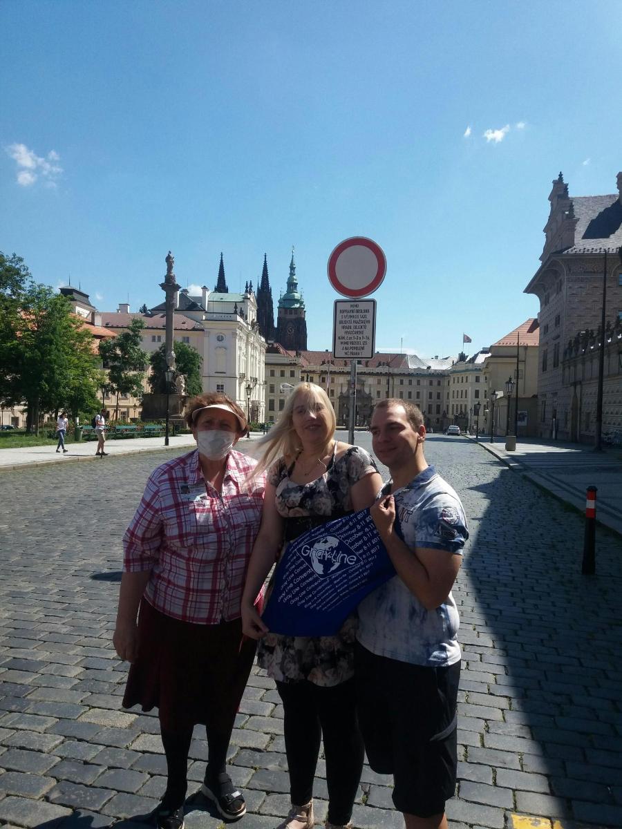 a group of three people standing on a street