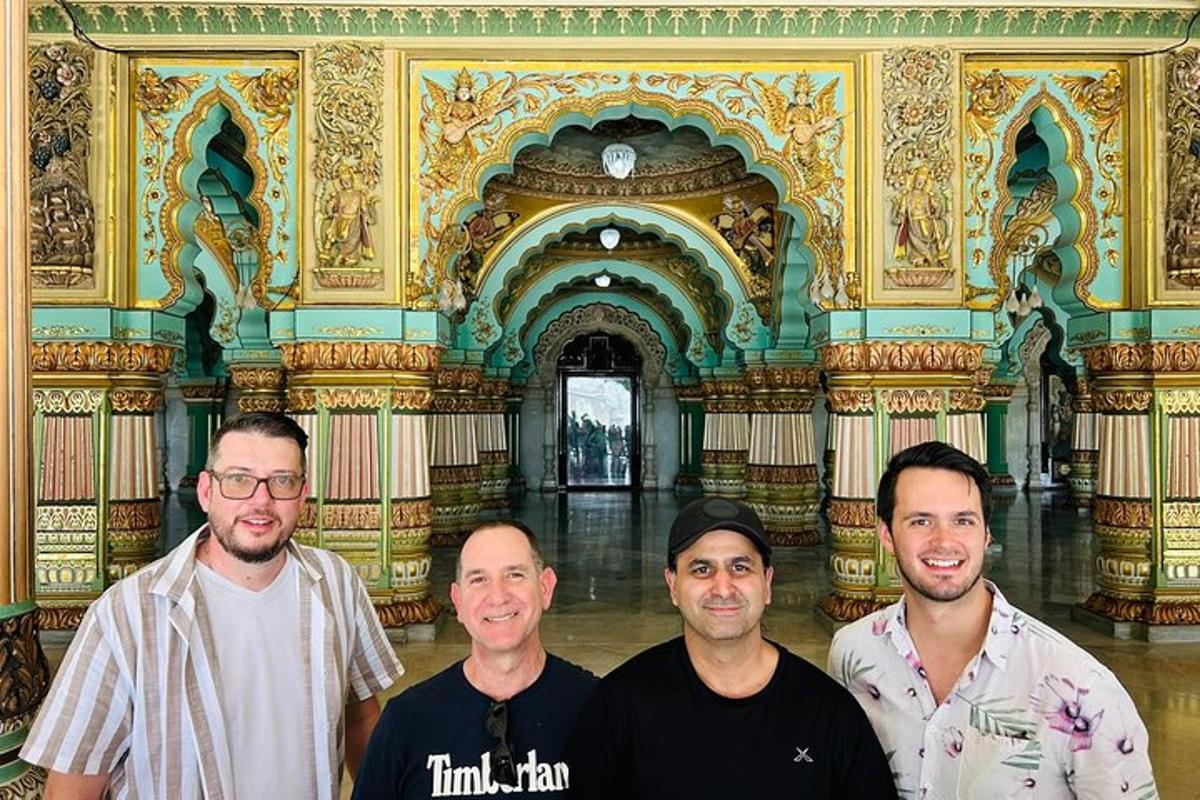 a group of four men standing in a building