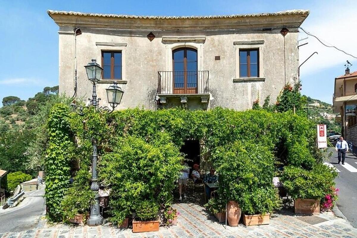a building with a lot of plants in front of it