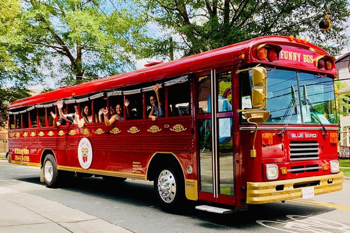 a red bus driving down a street with people inside