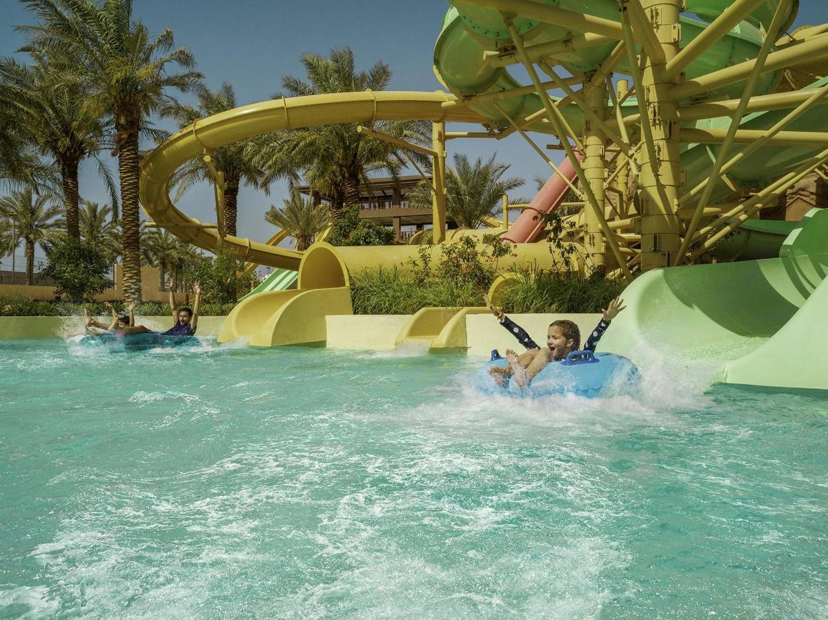 a child on a water slide at a water park