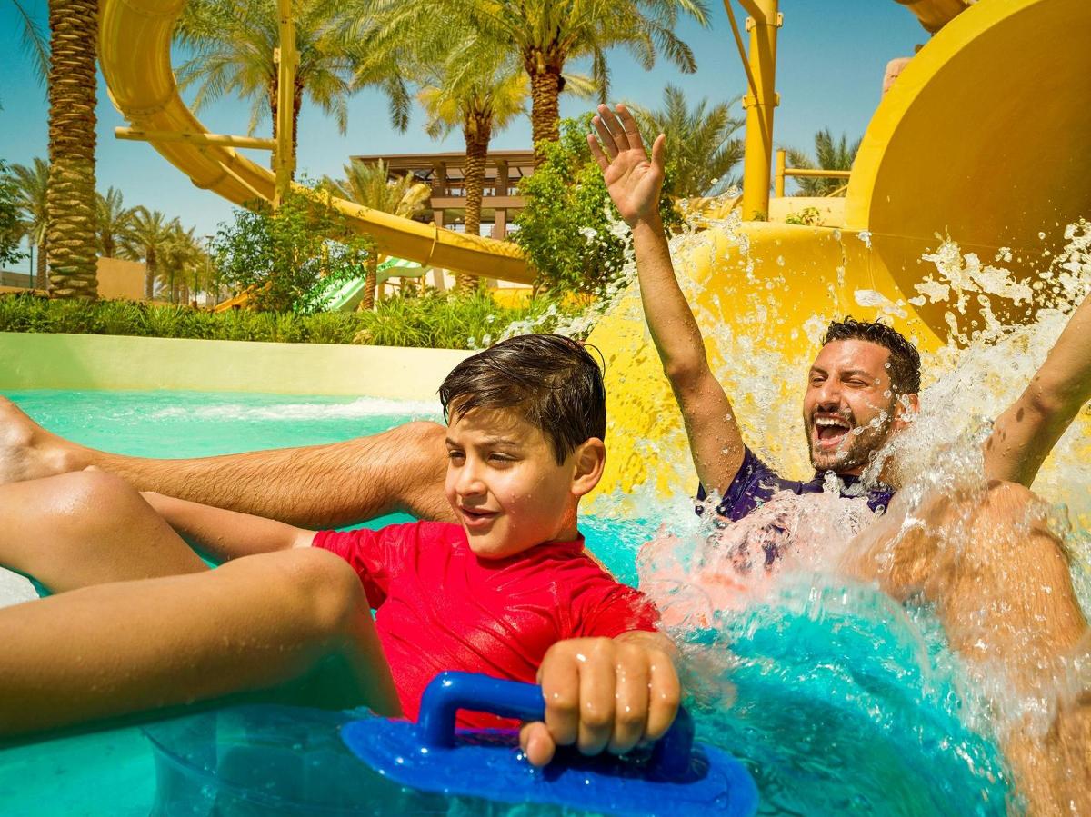 a group of people on a water slide at a resort