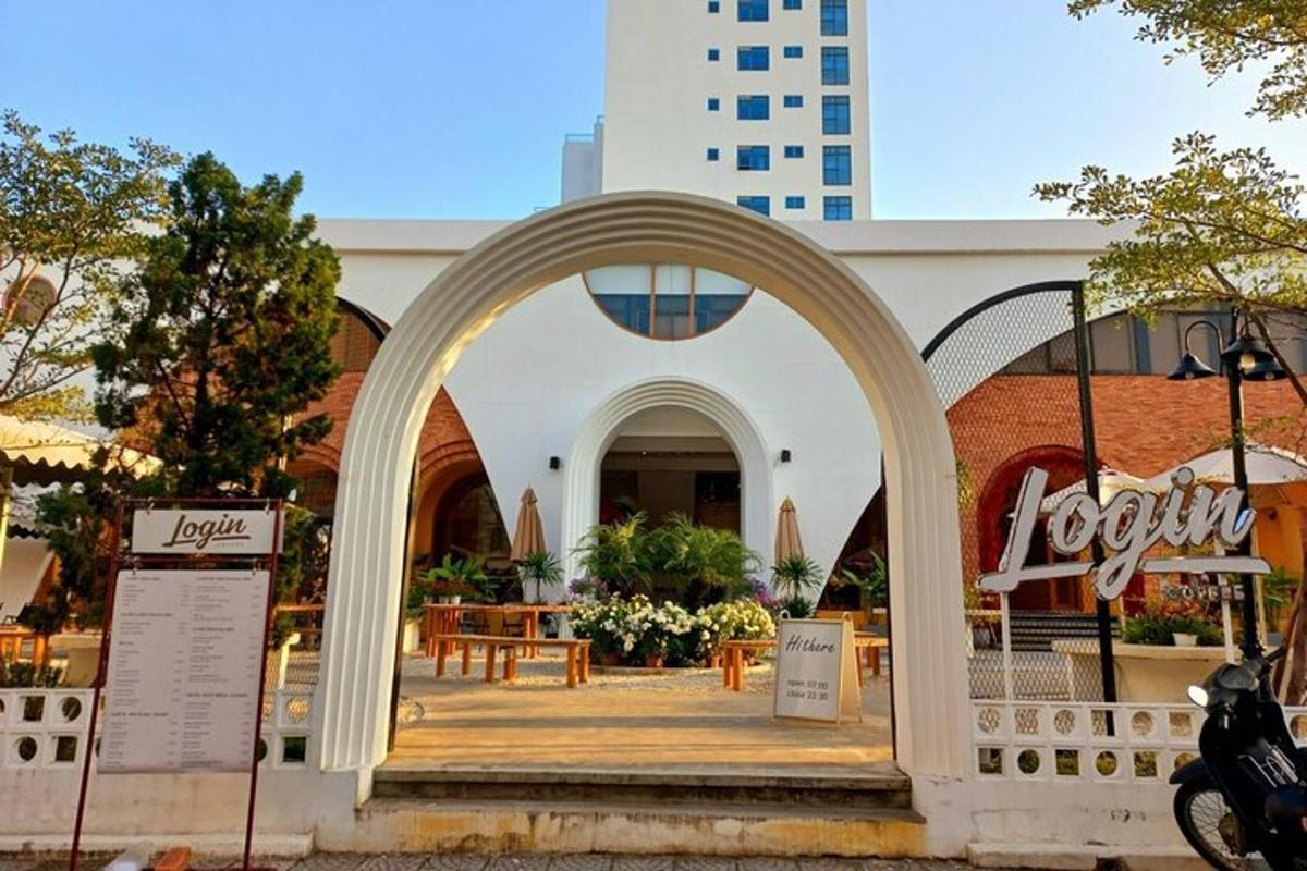 an archway in front of a building with tables and chairs