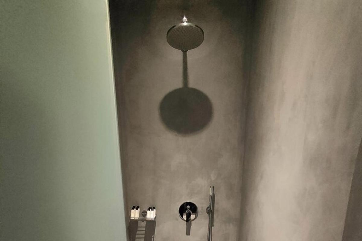 a bathroom with a shower stall with a light