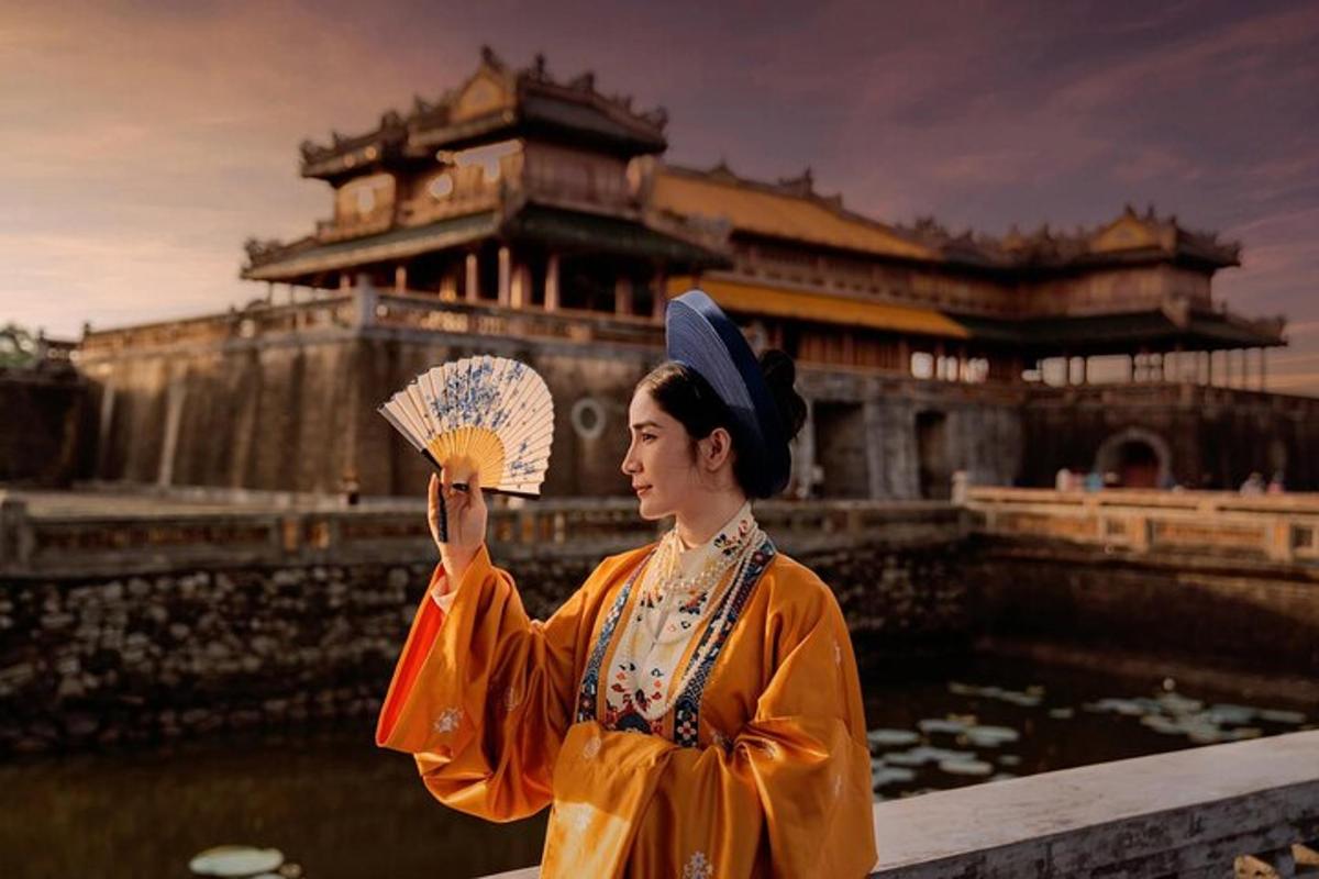 a woman holding a fan in front of a building