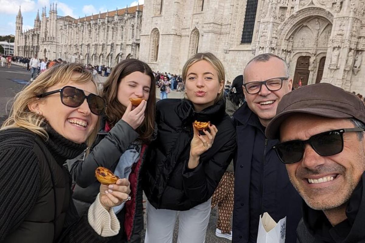 a group of people eating donuts in front of a cathedral