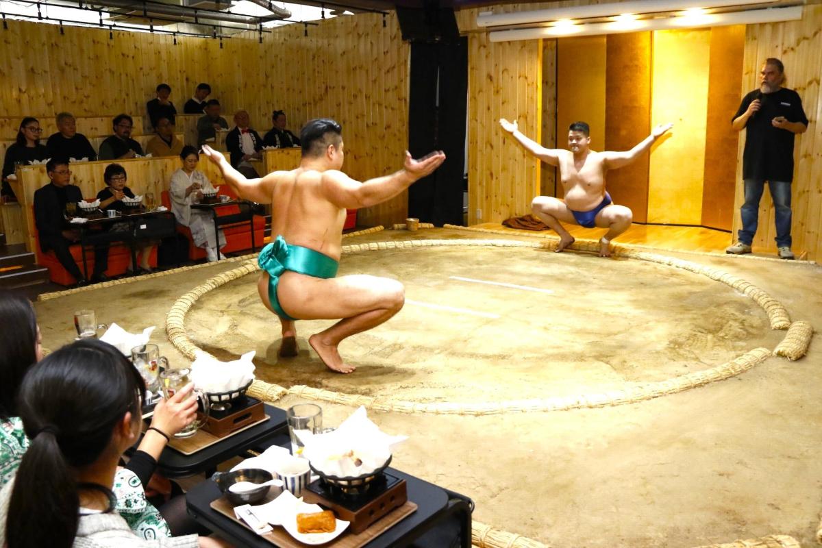 two men in bathing suits in a wrestling ring