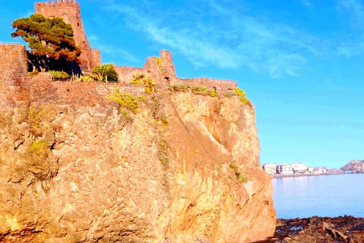 o stâncă cu un castel pe ea lângă apă