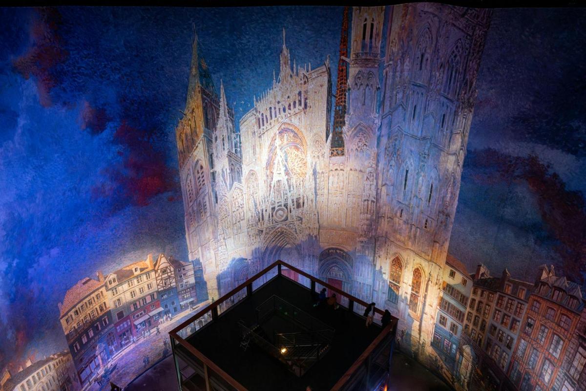 a rendering of a large building with lights on it