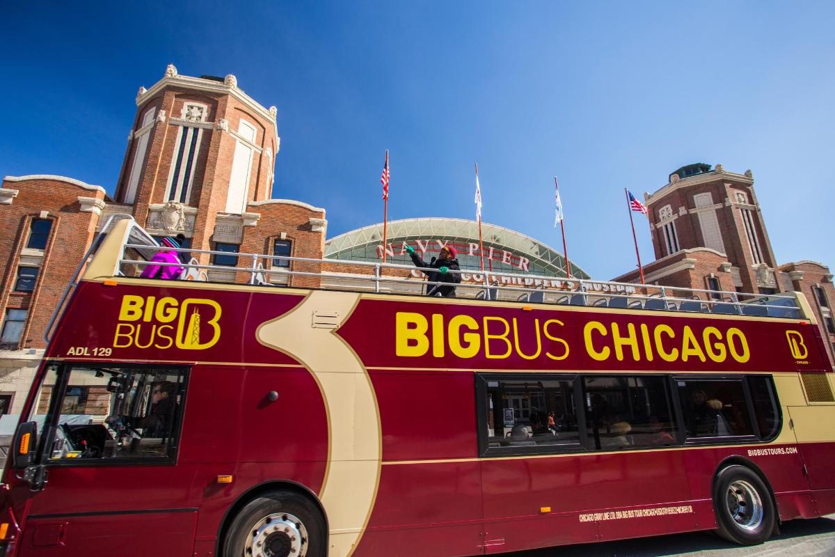 a red double decker bus parked in front of a building
