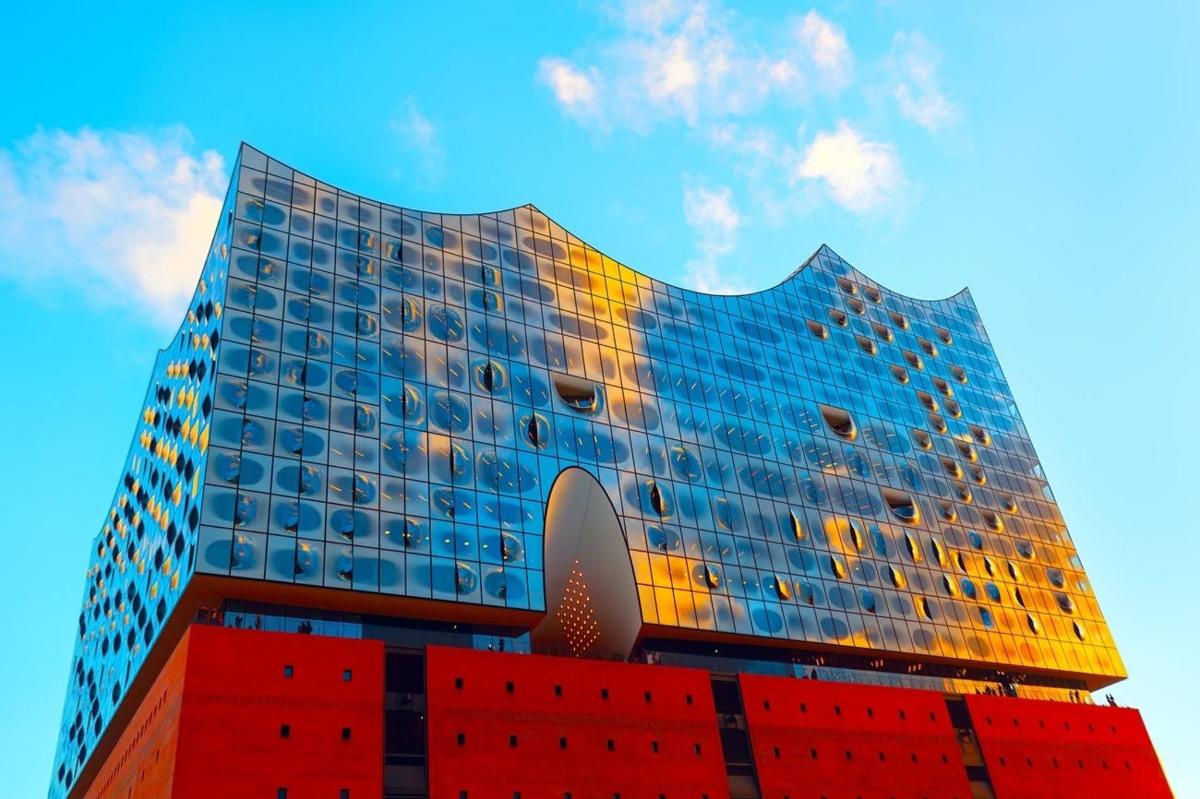 a tall building with a reflection of the sky