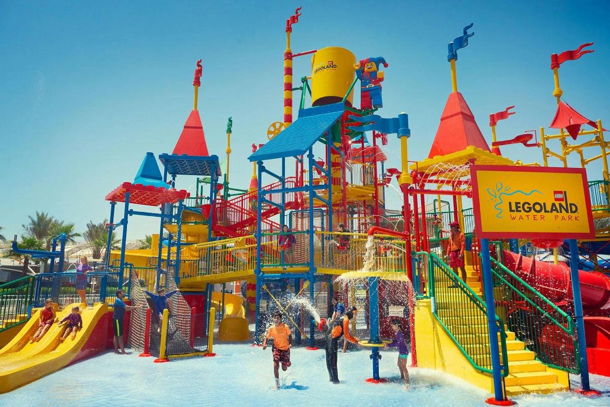 a group of people playing in a water park