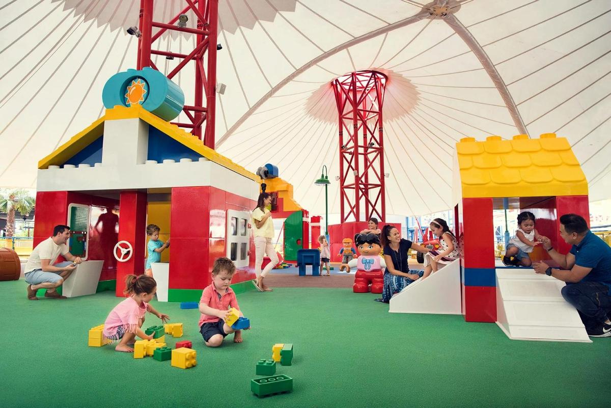 a group of children playing in an indoor play structure