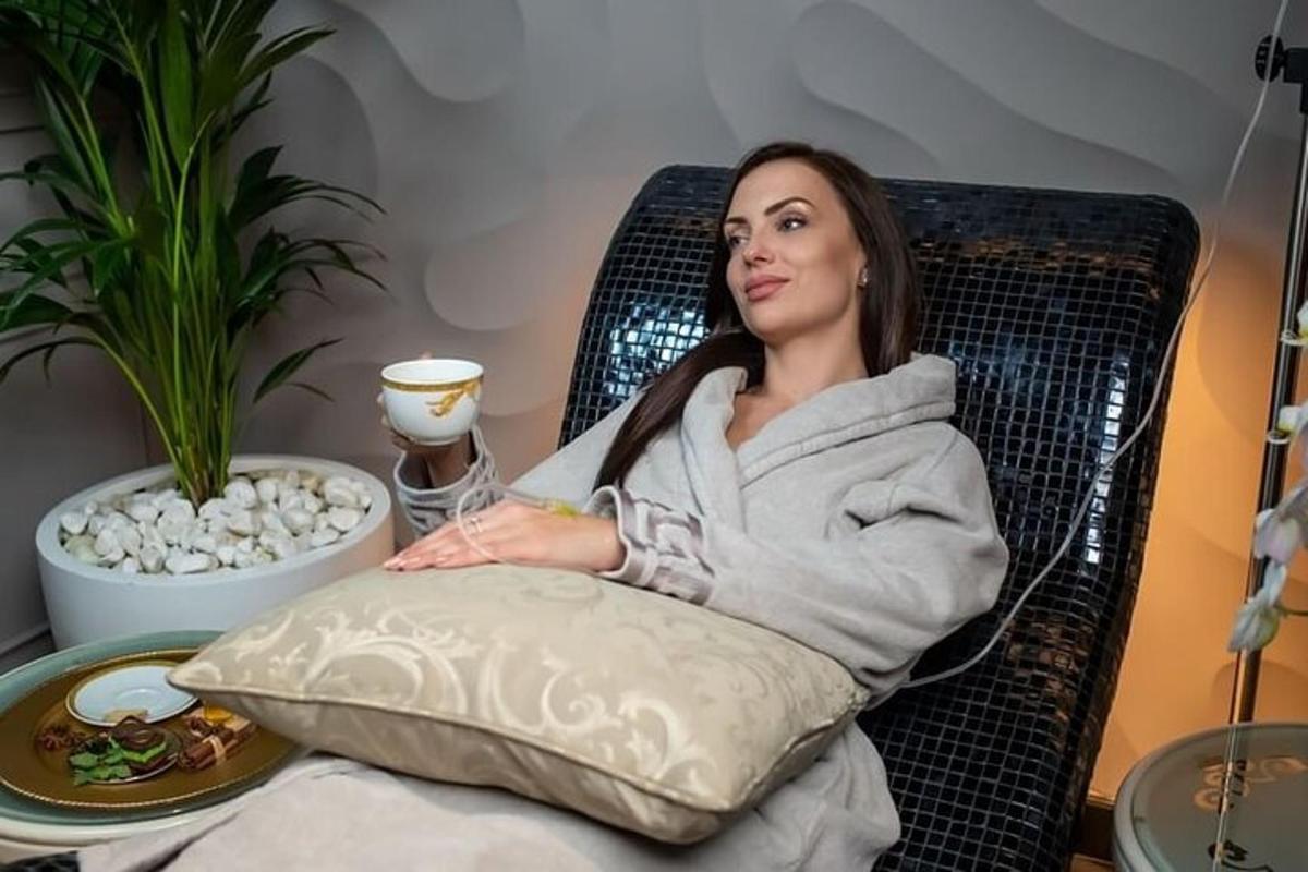 a woman sitting in a chair with a pillow