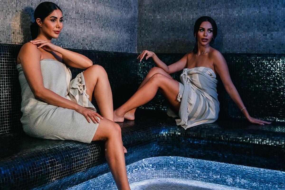 two women are sitting on a couch
