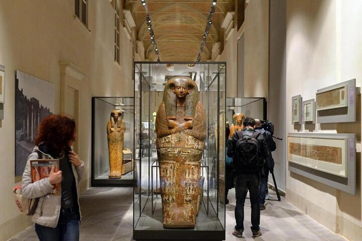 a group of people looking at a statue in a museum