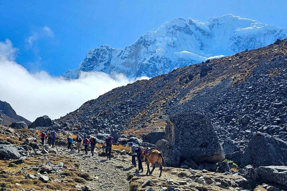 a group of people walking up a rocky mountain