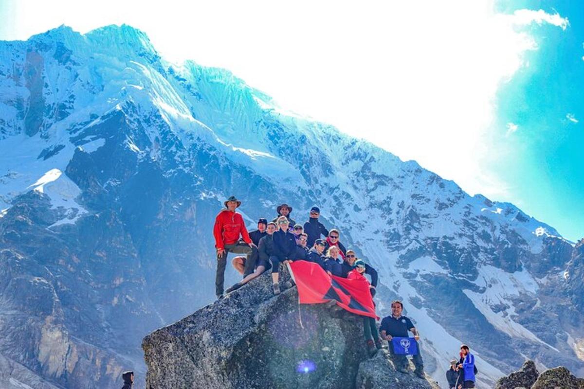 a group of people sitting on top of a mountain
