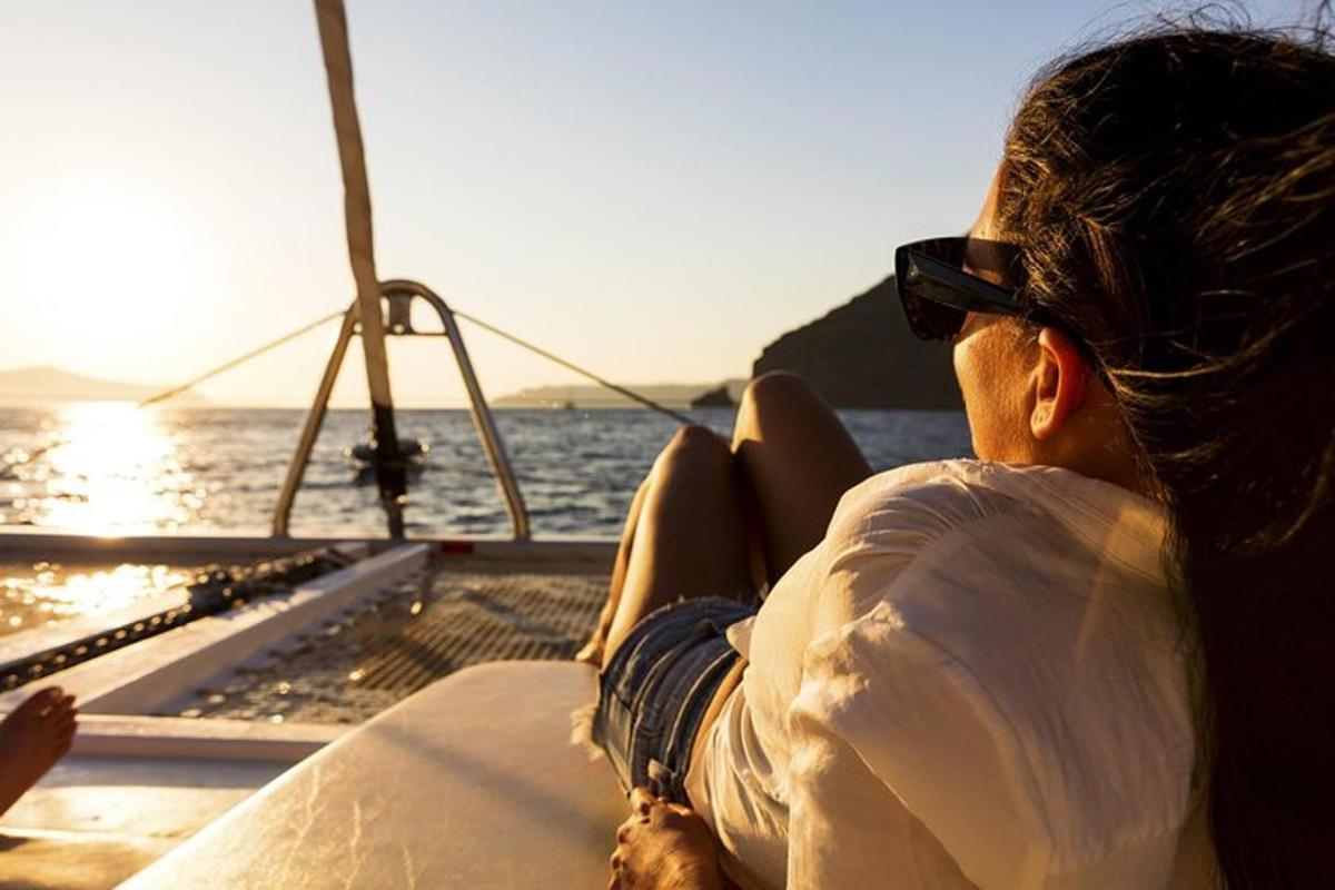 a person sitting on a boat looking out at the ocean