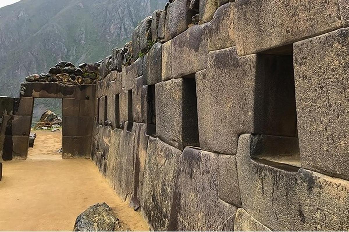 dinding batu besar dengan latar belakang gunung