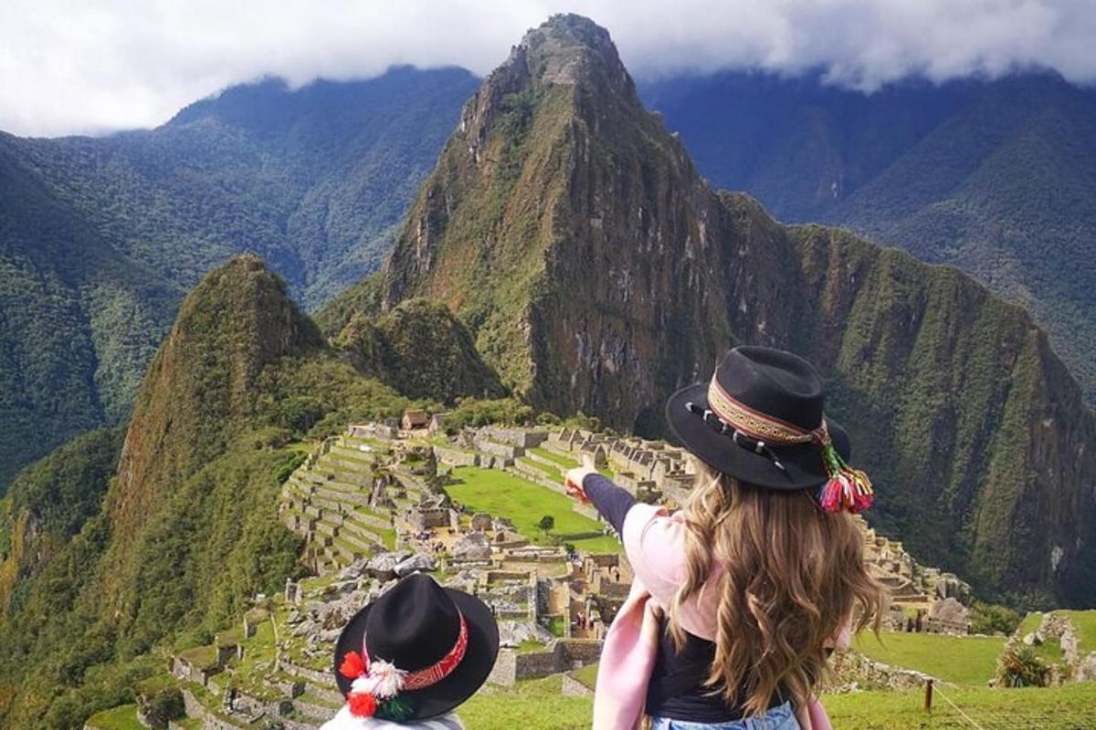 a woman standing on top of a mountain
