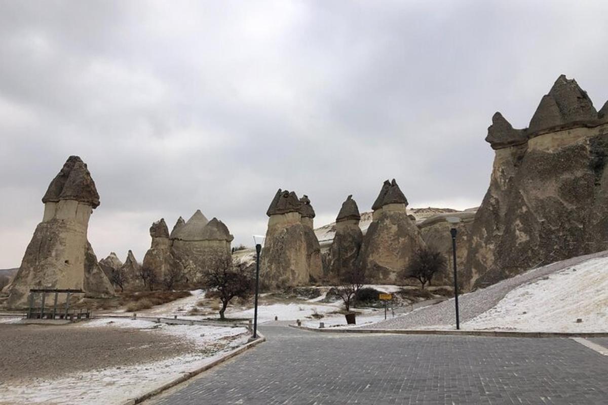 a road in a desert with large rock formations