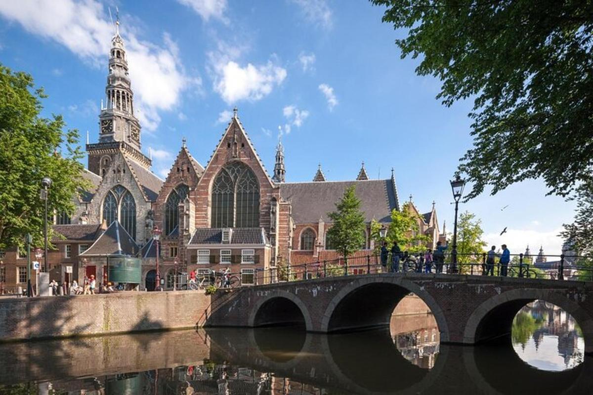 a bridge over a river in front of a church