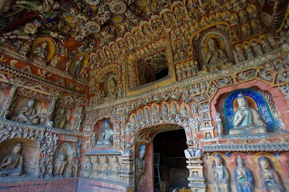 a room with a bunch of statues on the wall