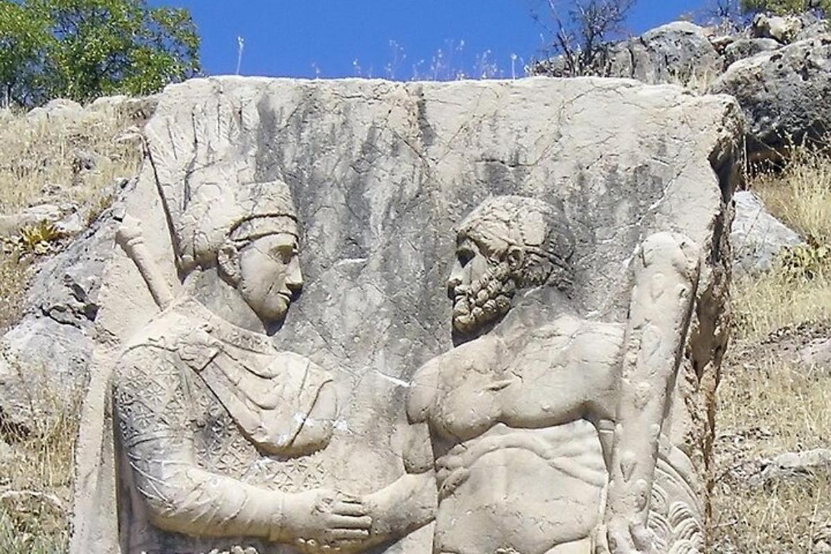 a statue of two people standing on a rock