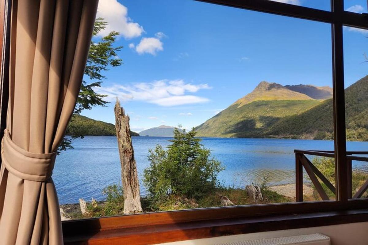 a window with a view of a lake and mountains